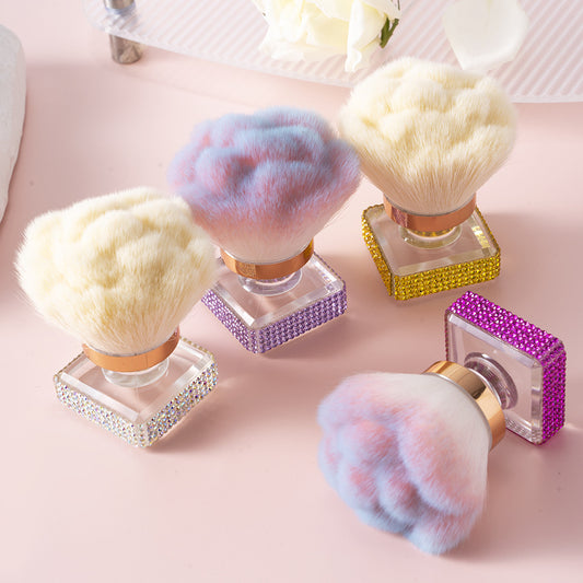 Makeup brushes with colorful bristles on decorative stands on a pink surface